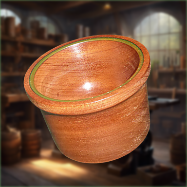 A wooden bowl with a green rim, positioned against a workshop background.